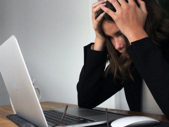 photo of stressed woman looking at laptop